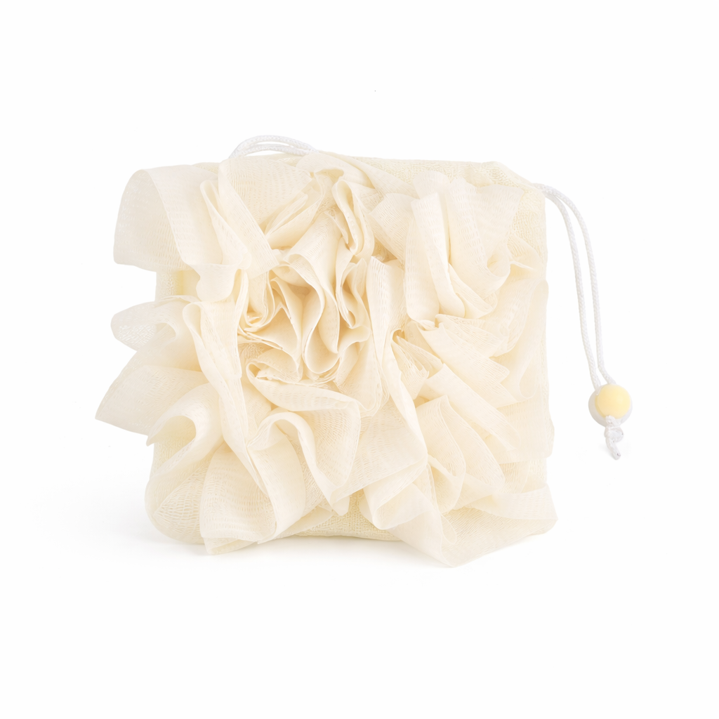 Beige drawstring bag with a flower-shaped object on a white background
